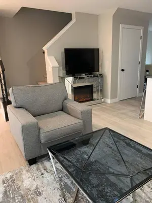 a living room with a couch and a television at New townhouse in Red Deer -Family retreat in Red Deer