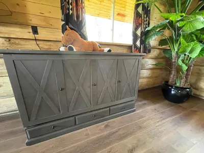 a cat sitting on top of a dresser in a room at The Ram cabin - Bear Creek cabins in Winfield