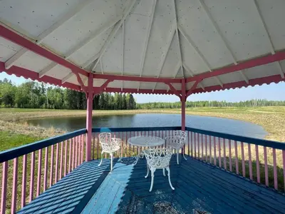a patio with a table and chairs on a deck at The Lynx cabin - Bear Creek Cabins in Winfield