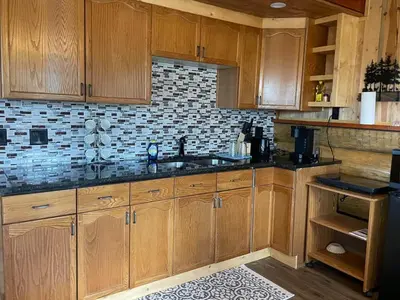 a kitchen with wooden cabinets and a sink at The Deerview cabin - a part of Bear Creek Cabins in Winfield