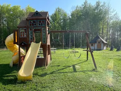 a playground with a slide and a play structure at The Sheep Camp cabin- Bear Creek Cabins in Winfield