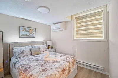 a bedroom with a bed and a window at Stylish 2BR Townhome - Near YYC Airport - Free Parking in Calgary