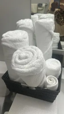 a basket filled with towels and toilet paper at Slice Of Paradise in Calgary