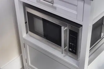a microwave oven in a cabinet in a kitchen at The Cozy Garden Suite - South Surrey Stay in White Rock