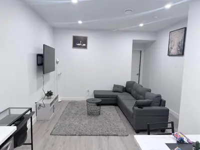 a living room with a couch and a tv at Charming Family-Friendly House Rental in Edmonton in Edmonton
