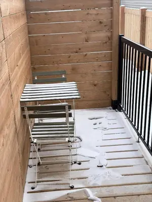 a pair of chairs and a table on a patio at Charming Family-Friendly House Rental in Edmonton in Edmonton