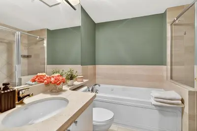 a bathroom with a tub and a sink and a toilet at Stunning 2BR Apartment with Best Mountain View Downtown in Vancouver