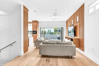 a living room with two couches and a kitchen at Fabulous Modern Home Near Downtown Vancouver in Vancouver