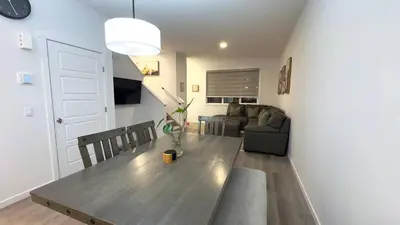 a living room with a table and a couch at 3BR Family House in NE Edmonton in Edmonton