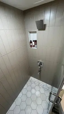 a bathroom with a shower stall with a toilet at Cozy 2 bedroom suite in Edmonton