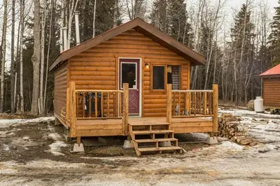 a log cabin with a porch and a door at The Wolf Cabin - Bear Creek Cabins in Winfield