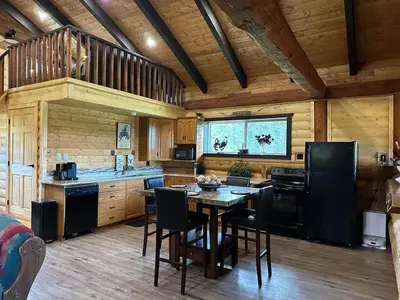 a kitchen with a table and chairs in a cabin at The Yellowstone cabin - part of Bear Creek Cabins in Winfield