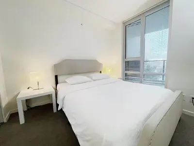 a white bedroom with a white bed and a window at Bright & Cozy 2B2B near transit in Richmond in Richmond
