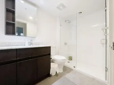 a white bathroom with a toilet and a shower at Bright & Cozy 2B2B near transit in Richmond in Richmond