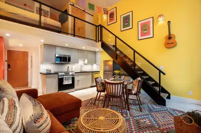 a living room with a staircase and a dining room at Casa DT Vancouver - Mexican Theme in Vancouver