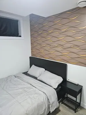 a bedroom with a bed and a painting on the wall at Your home away from home comfortable, and calm, in Edmonton