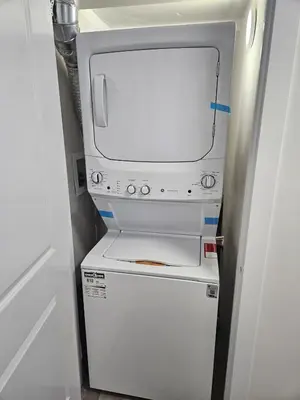 a small white refrigerator with a tv inside of it at Your home away from home comfortable, and calm, in Edmonton