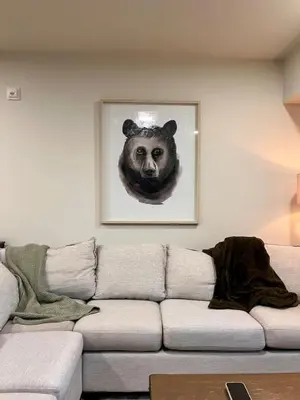a living room with a couch with a picture of a bear at New Condo with Pool and Hot Tub Sleeps 9 in Canmore