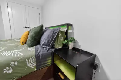 a living room with a couch and a table with a tv at New 2BR Home - Family Friendly - Near YYC Airport & Downtown - 4412 - DN in Calgary
