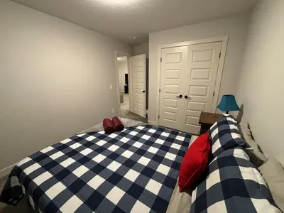 a bedroom with a blue and white checkered bed at Luxury 3bedroom House with Kingsize Master bedroom in Airdrie