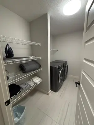 a laundry room with a washing machine in it at Luxury 3bedroom House with Kingsize Master bedroom in Airdrie