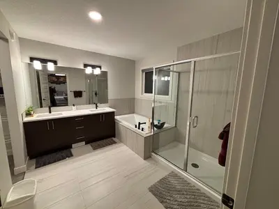 a bathroom with a shower and a sink at Luxury 4 Bedroom Entire House with Basement in Airdrie
