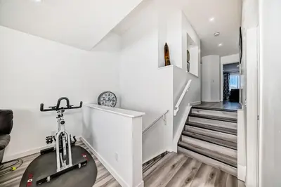 a staircase in a house with a bike in a room at Cozy Vacation Home in Calgary