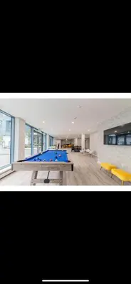 two pictures of a room with a table and benches at Cozy 1 bed and 1bath suit in Surrey