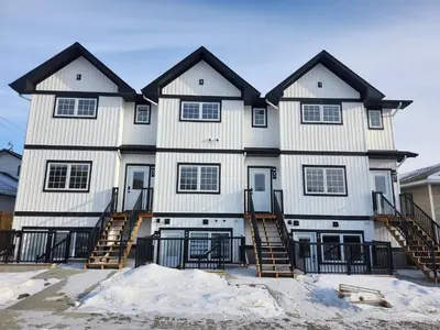 a large white house with black roof at Harmony Haven in Drumheller in Drumheller