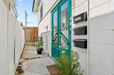 a green door on the side of a building at Bright and Open Coziness. 10 minutes to Stampede in Calgary