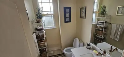 a bathroom with a white toilet and a sink at Premium stay in Metro Vancouver-World Cup ready in Coquitlam