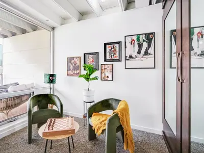 a living room with two chairs and a table at Luxury 2BR 2BA Loft Ice District W Heated Parking in Edmonton