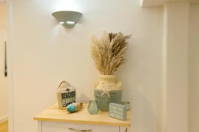 a shelf with a vase with a plant on it at Poolside Shared Suite - Private Queen Room with Heated Pool in Victoria