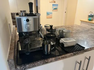 a kitchen with a coffee maker on a counter at Poolside Shared Suite - Private Queen Room with Heated Pool in Victoria