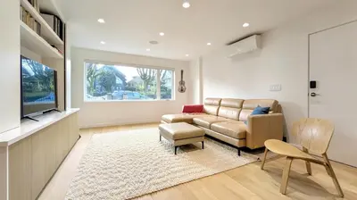 a living room with a couch and a tv at Modern 3-Bdrm Home & Parking - Cambie Village-VGH in Vancouver