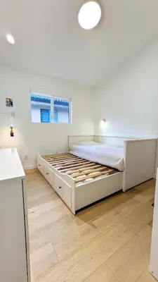 a bedroom with a large bed in a room at Modern 3-Bdrm Home & Parking - Cambie Village-VGH in Vancouver