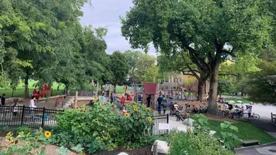 a park with a playground with people sitting on benches at Modern 3-Bdrm Home & Parking - Cambie Village-VGH in Vancouver