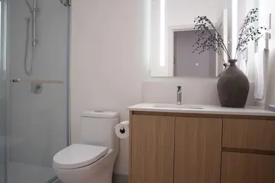 a bathroom with a toilet and a sink with a vase at Luna Ridge - Thoughtfully Designed 3-Bedroom Condo in Revelstoke
