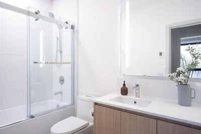 a bathroom with a toilet and a sink and a shower at Luna Ridge - Thoughtfully Designed 3-Bedroom Condo in Revelstoke