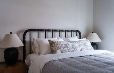 a bedroom with a bed with pillows and two lamps at Luna Ridge - Thoughtfully Designed 3-Bedroom Condo in Revelstoke