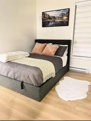 a bedroom with a large bed with a wooden floor at Luxury 2-Bedroom Suite at Bear Mountain Victoria in Langford