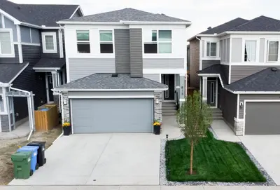 a house with a garage in front of it at Cozy Luxe 1BR Suite in Calgary