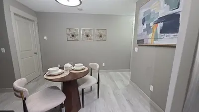 a dining room with a small table and chairs at SkyHaven Urban Condo near YYC Airport in Calgary