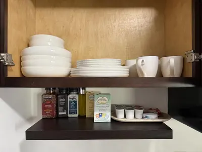 a shelf with plates and cups and dishes on it at Private 1BR, AC, Strong Wi-Fi, Netflix and Amazon Prime in Victoria