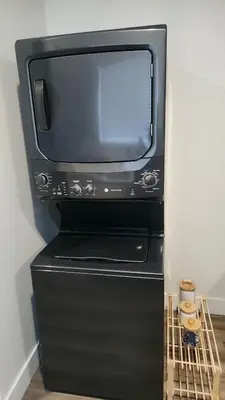 a microwave oven sitting on top of a refrigerator at Hebzibah's Luxe in Prince George
