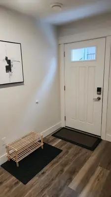 a room with a door and a bench in front of it at Hebzibah's Luxe in Prince George