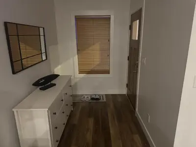 a white room with a desk and a window at Next rental in Vernon