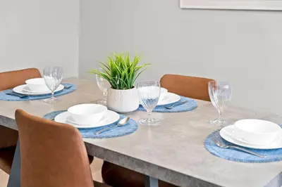 a dining room table with plates and glasses on it at Modern House-3BR/Spacious good for 8/Free Parking in Edmonton