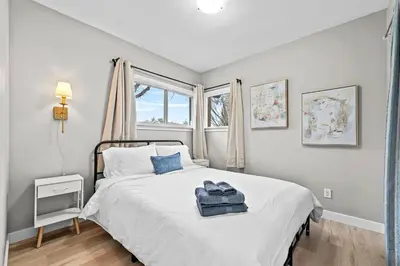 a bedroom with a white bed and a window at Modern House-3BR/Spacious good for 8/Free Parking in Edmonton