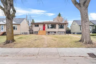 a house with a red door and two trees at Modern House-3BR/Spacious good for 8/Free Parking in Edmonton